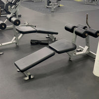 Gym equipment including weight benches and dumbbells with 'GetFit' branding in the background.
