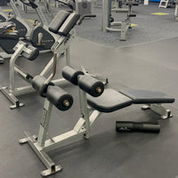 Gym equipment including weight bench and dumbbells in a fitness center 
